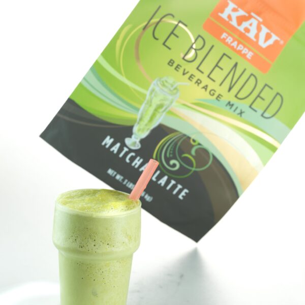 A glass of frothy green matcha latte with a pink straw sits in front of an Ice Blended Matcha Latte (3lb) package.